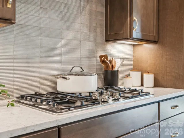 a stove top oven sitting inside of a kitchen
