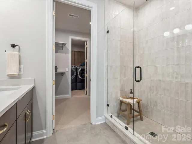 a bathroom with a shower and a sink