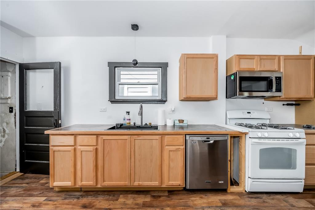925 Roup Avenue Brackenridge, PA 15014 - Photo 12 of 28 a kitchen with stainless steel appliances granite countertop a stove a sink and a microwave