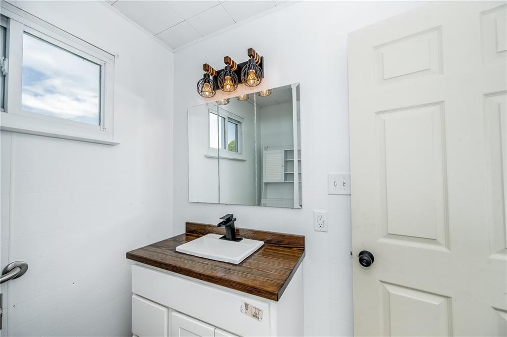 925 Roup Avenue Brackenridge, PA 15014 - Photo 14 of 28 a bathroom with a sink and a mirror