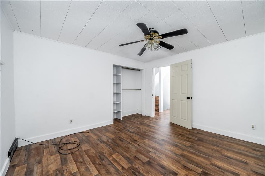 925 Roup Avenue Brackenridge, PA 15014 - Photo 16 of 28 a view of empty room with wooden floor and fan