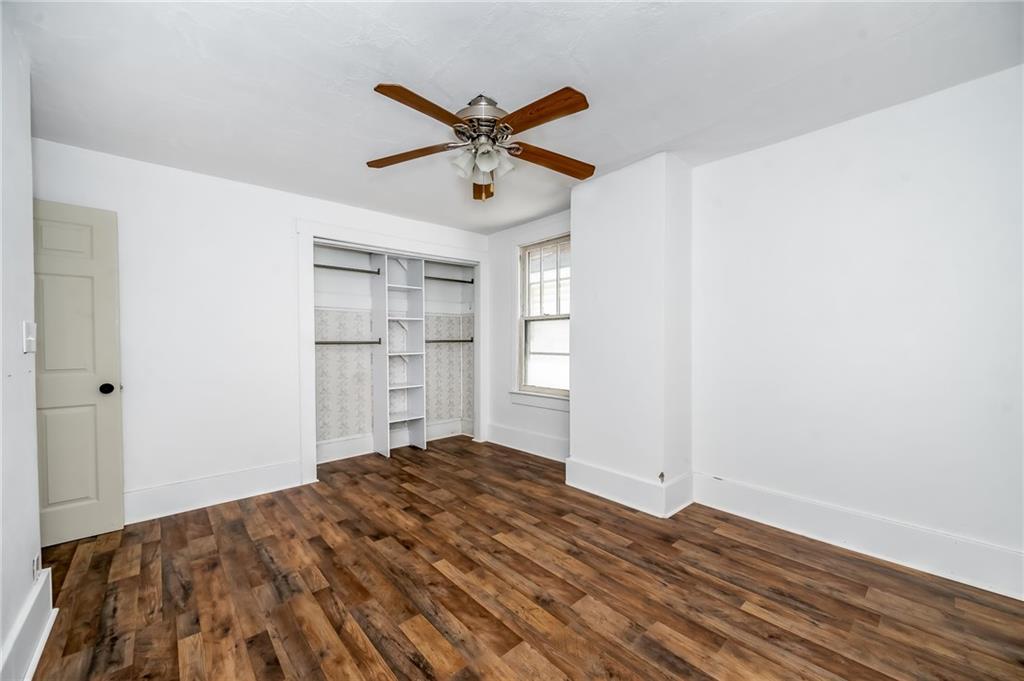 925 Roup Avenue Brackenridge, PA 15014 - Photo 18 of 28 a view of a livingroom with a hardwood floor and a ceiling fan