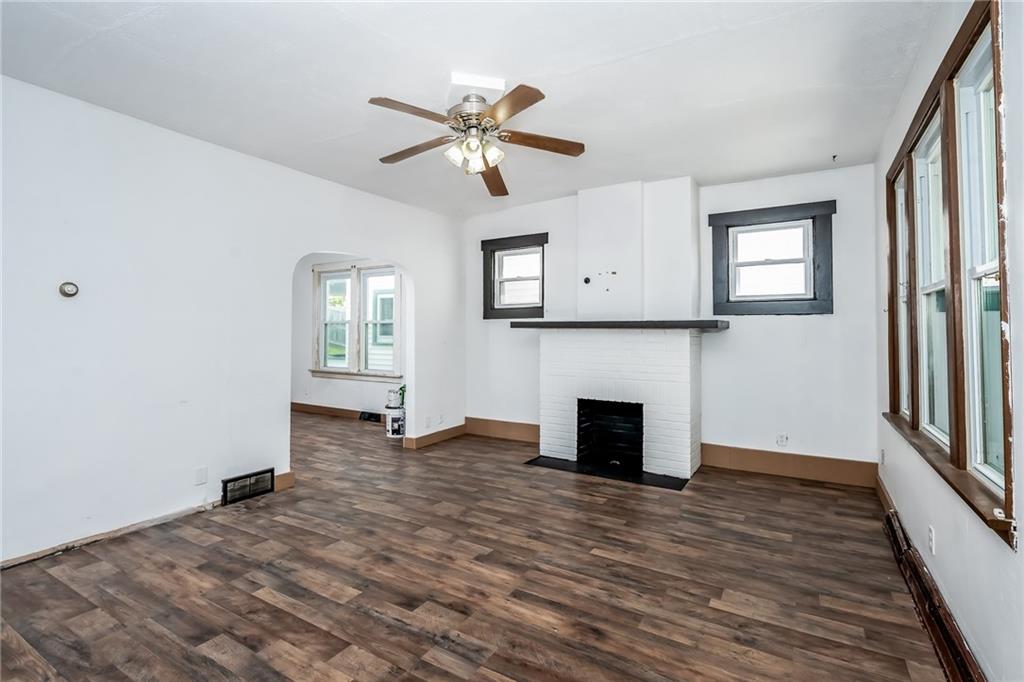 925 Roup Avenue Brackenridge, PA 15014 - Photo 5 of 28 wooden floor fireplace and windows in an empty room