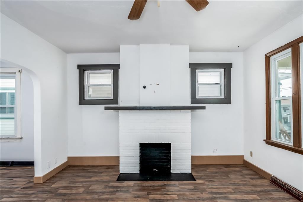 925 Roup Avenue Brackenridge, PA 15014 - Photo 6 of 28 a living room with furniture and a fireplace