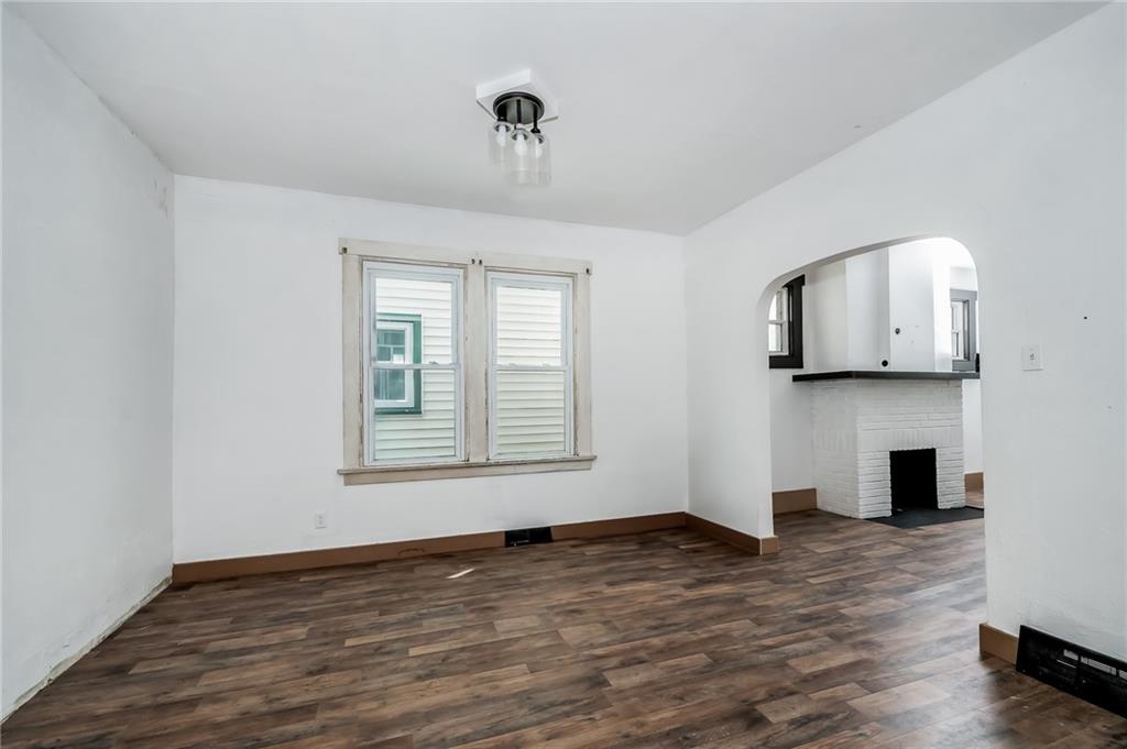 925 Roup Avenue Brackenridge, PA 15014 - Photo 9 of 28 a view of an empty room with wooden floor and a window