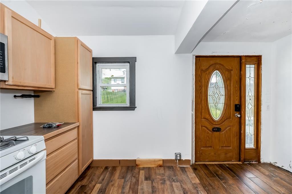 925 Roup Avenue Brackenridge, PA 15014 - Photo 10 of 28 a room with wooden floor and white cabinets