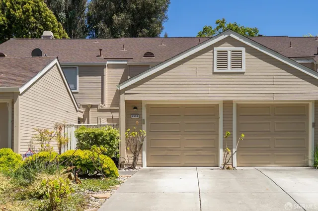 a view of small house with garage