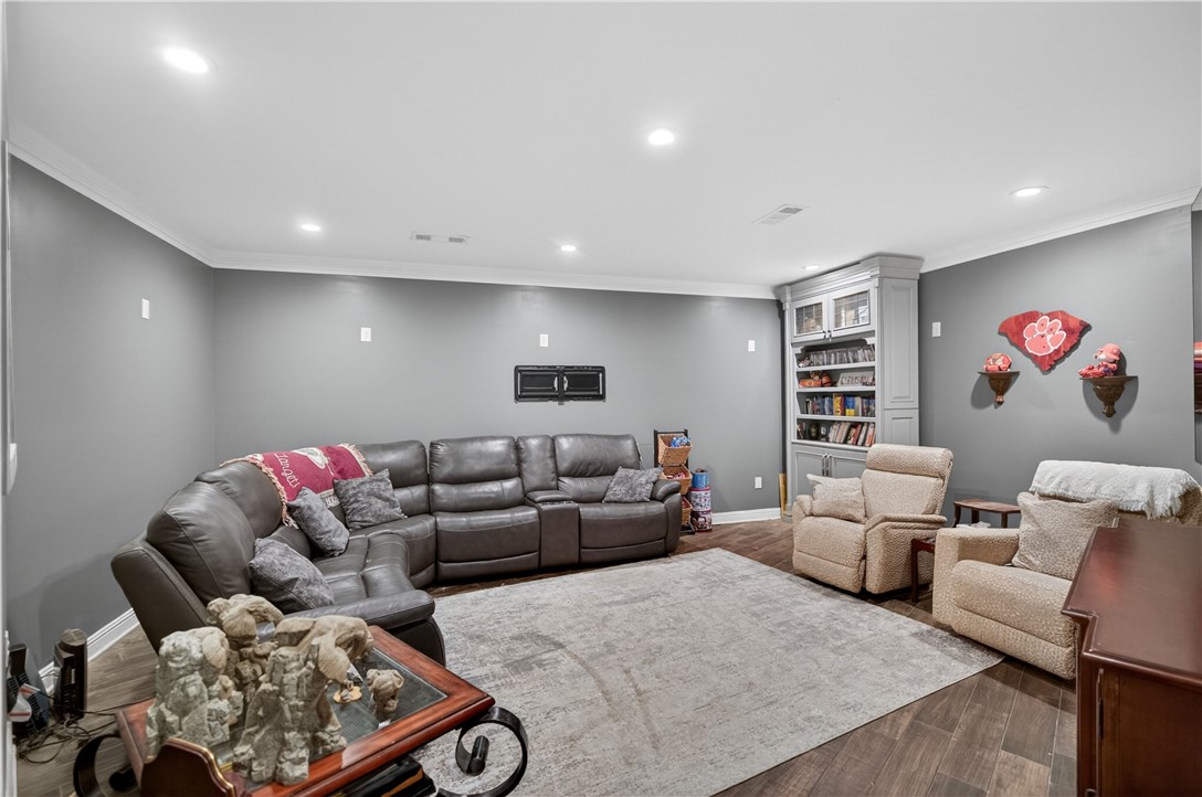 206 James Hare Road Anderson, SC 29626 - Photo 13 of 37 Comfortable seating and built-in shelving create a welcoming space for relaxation and entertainment.