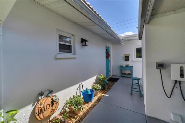 a house with potted plants in front of it