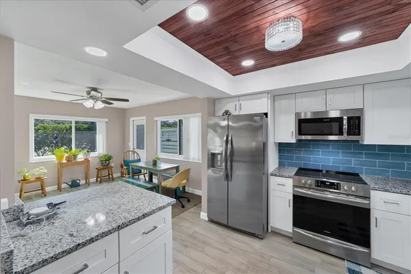 a large kitchen with a table and chairs