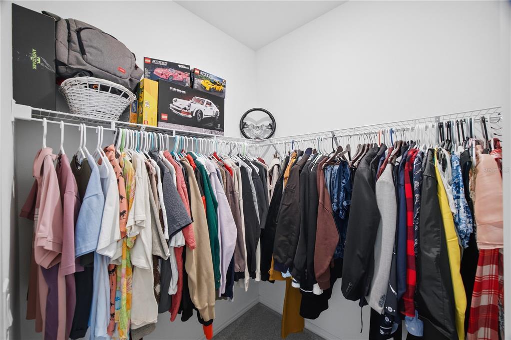 13816 Sharp Hawk Drive Riverview, FL 33569 - Photo 57 of 76 a view of walk in closet with clothes