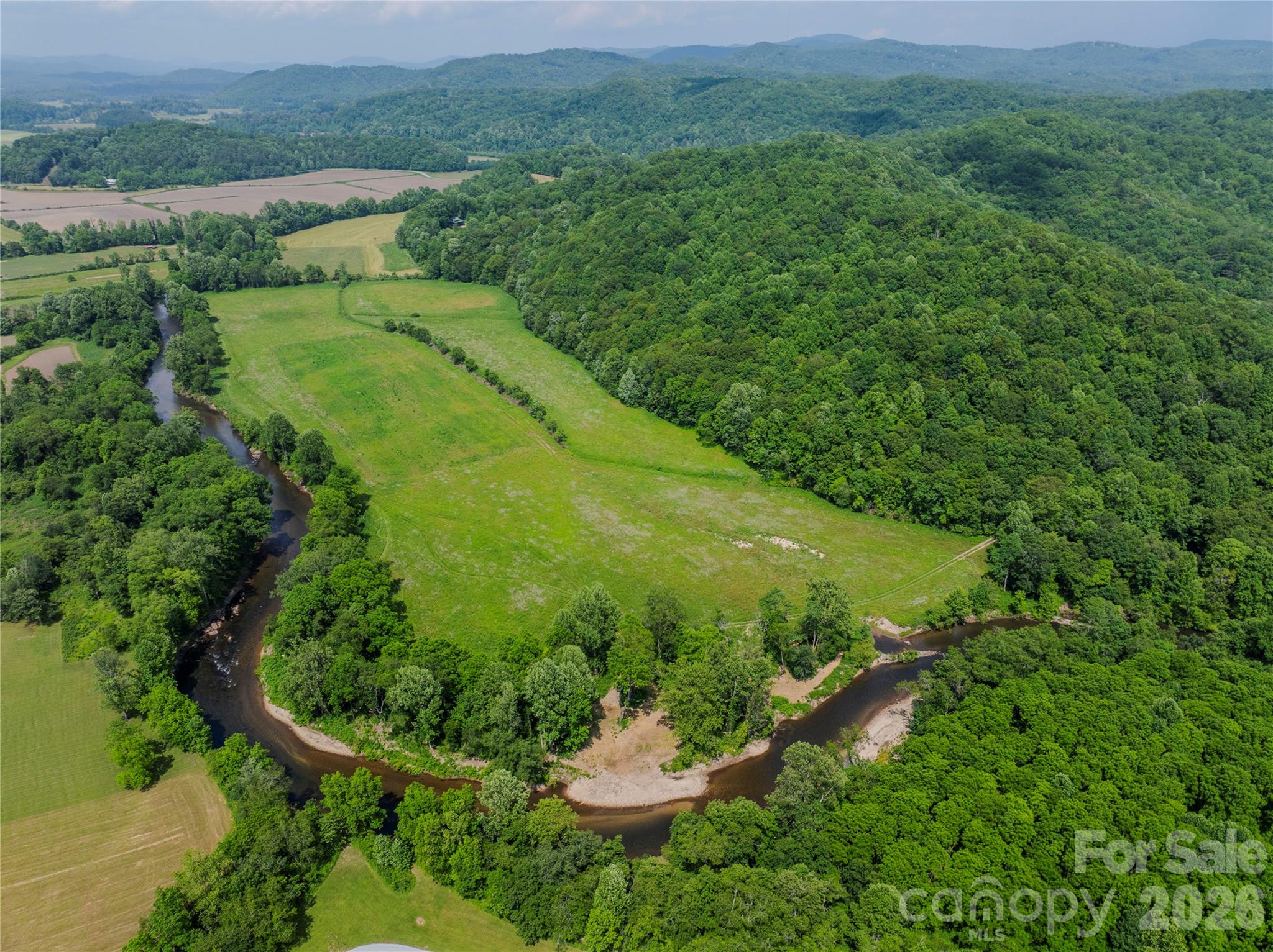 80 Orr Road Brevard, NC 28712 - Photo 2 of 2 a view of a garden with a building in the background