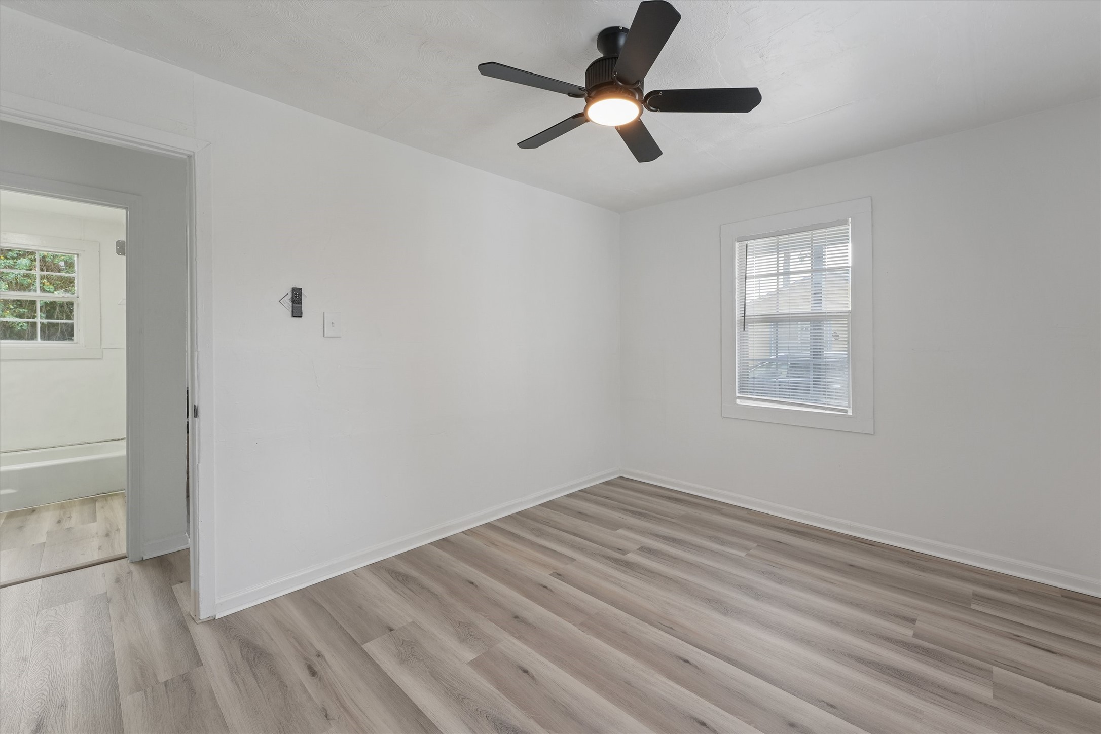 8514 Spaulding Street Houston, TX 77016 - Photo 3 of 19 wooden floor in an empty room with a window