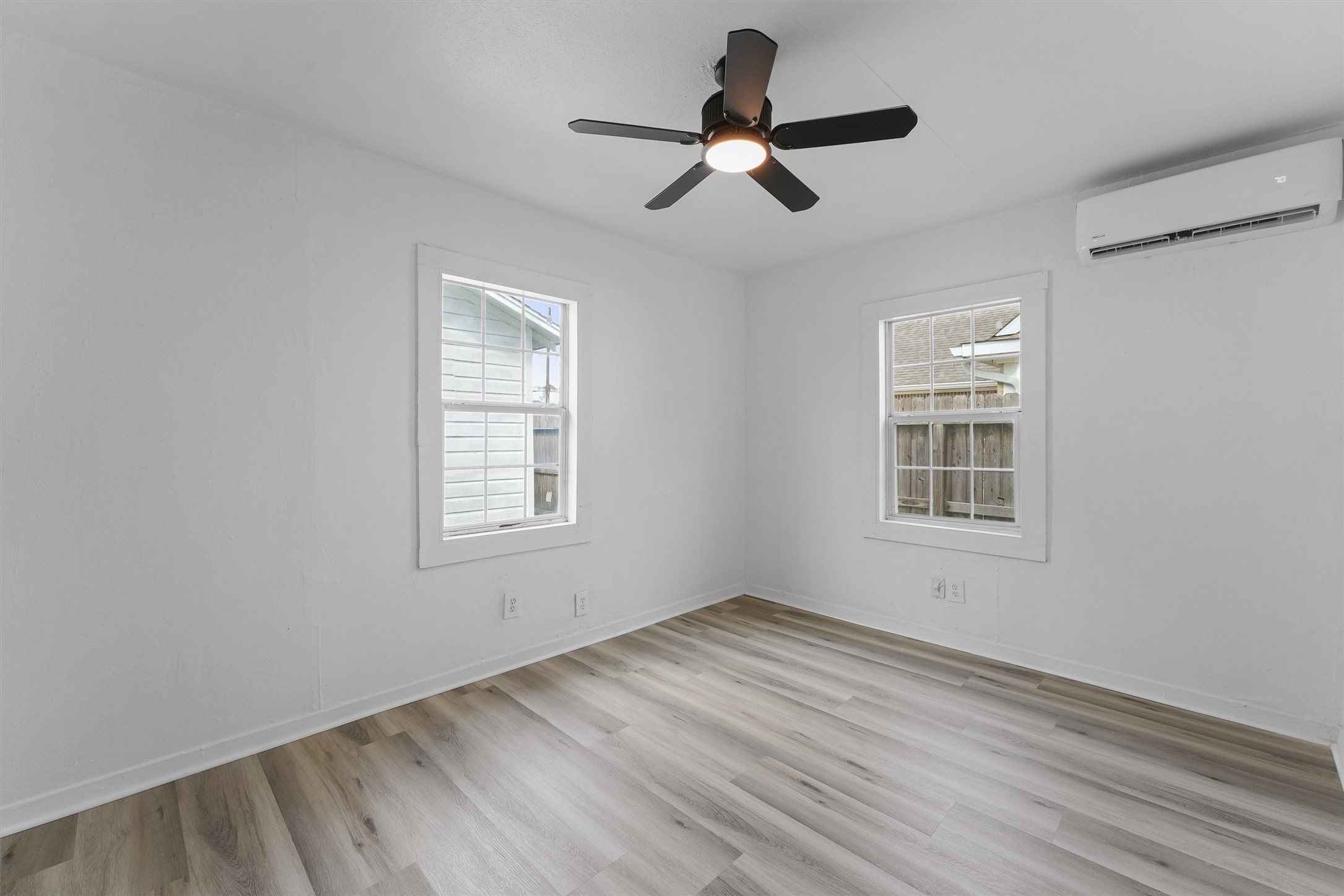 8514 Spaulding Street Houston, TX 77016 - Photo 5 of 19 a view of empty room with wooden floor and fan