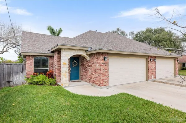 a front view of a house with a garden and yard