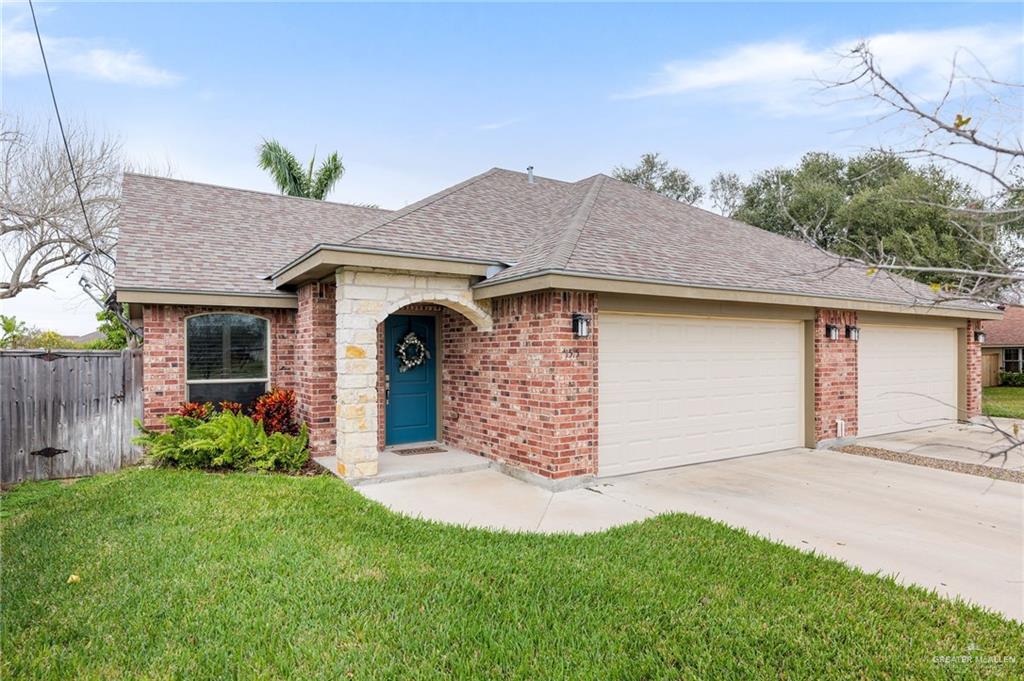 a front view of a house with a garden and yard