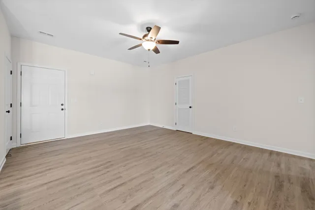 a kitchen with stainless steel appliances granite countertop a sink a stove a refrigerator and island with wooden floor