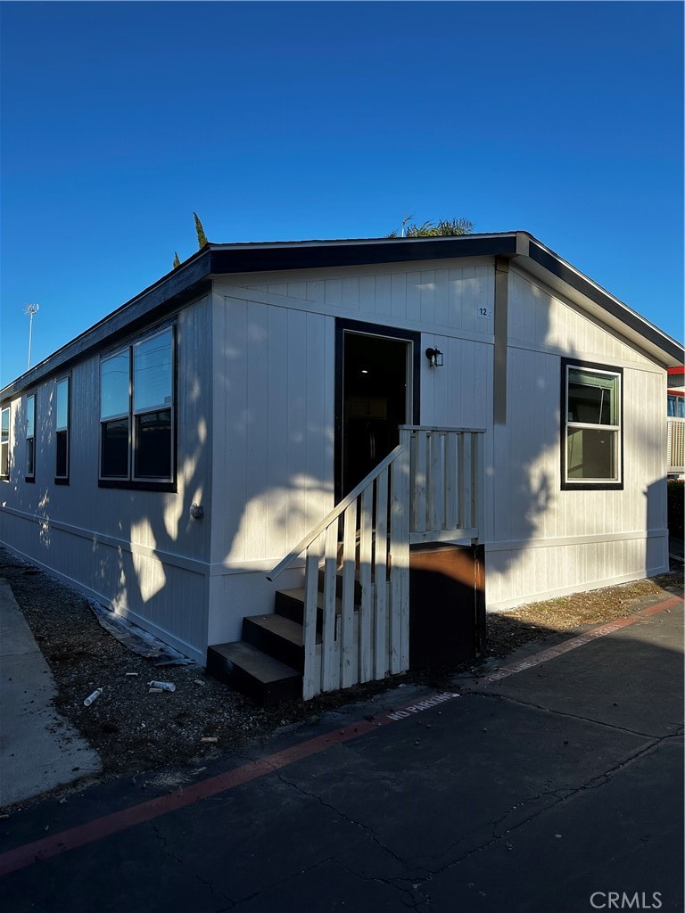 a backyard of a house with wooden floor fire pit and outdoor seating