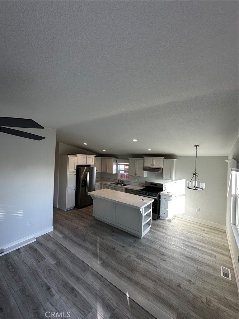 21845 Grand Terrace Road, Unit 12 Grand Terrace, CA 92313 - Photo 3 of 7 a kitchen with a sink cabinets and wooden floor