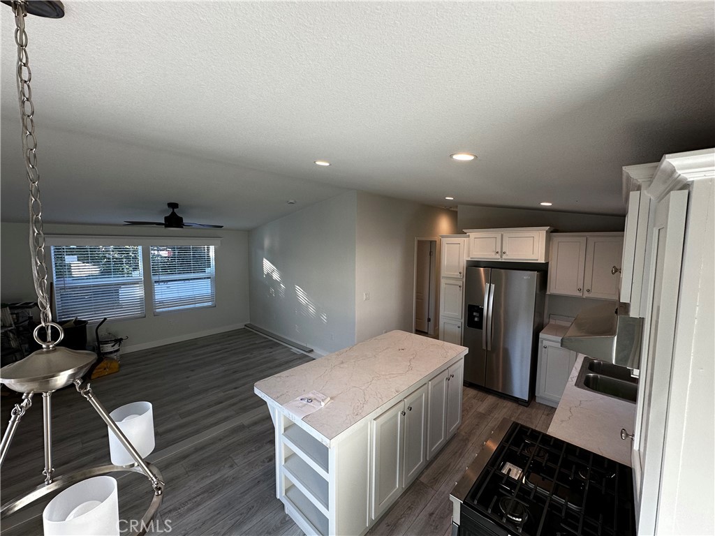 21845 Grand Terrace Road, Unit 12 Grand Terrace, CA 92313 - Photo 4 of 7 a bedroom with a bed and wooden floor