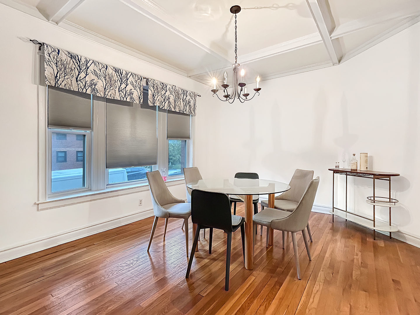 1400 East 56th Street, Unit 1 Chicago, IL 60637 - Photo 14 of 23 a view of a dining room with furniture wooden floor and chandelier