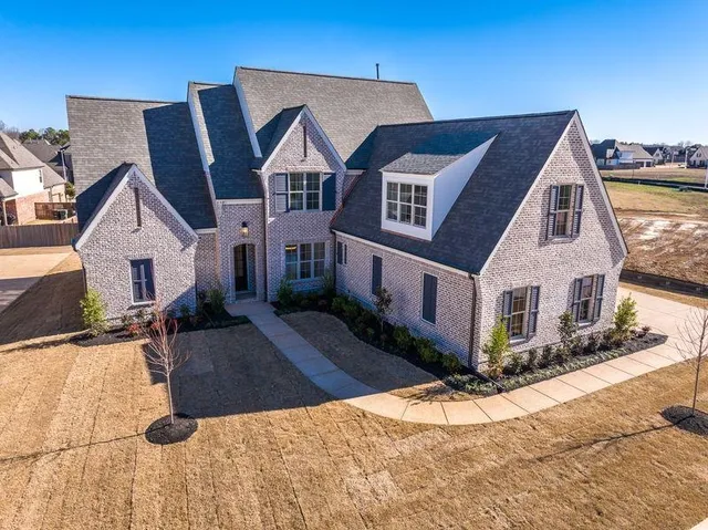 a view of a white house with a yard