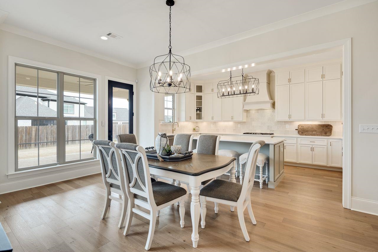 606 Cedar Shadows Circle West Collierville, TN 38017 - Photo 11 of 35 a view of a dining room with furniture wooden floor and chandelier