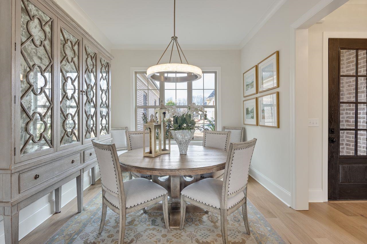 606 Cedar Shadows Circle West Collierville, TN 38017 - Photo 7 of 35 a dining room with furniture a chandelier and wooden floor