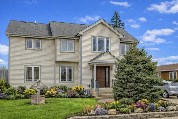 a front view of a house with a garden