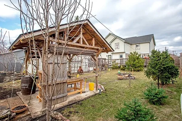 a view of a house with backyard and sitting area