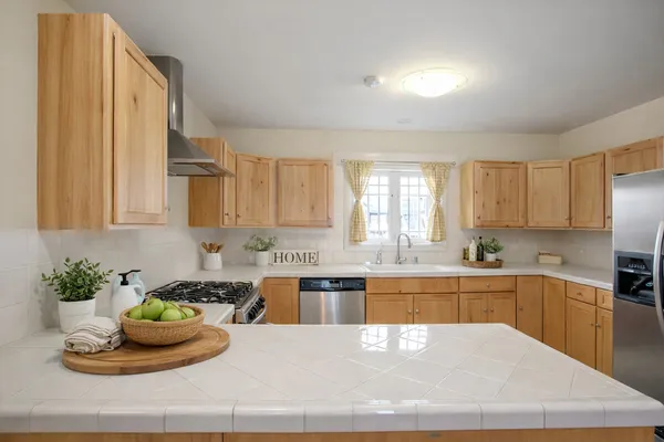 a kitchen with a stove a sink and a counter top space