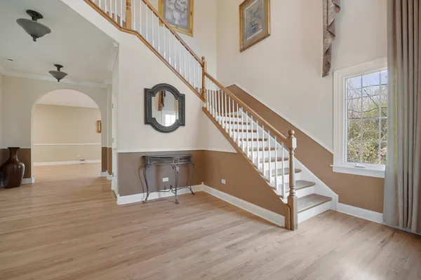 a view of entryway and hall with wooden floor