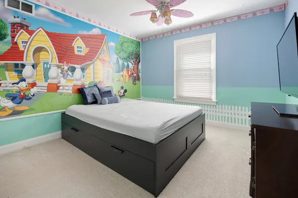 a bedroom with a bed and a window