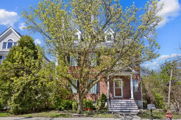 a view of a house with a tree