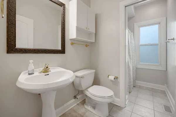 a bathroom with a sink a toilet and mirror