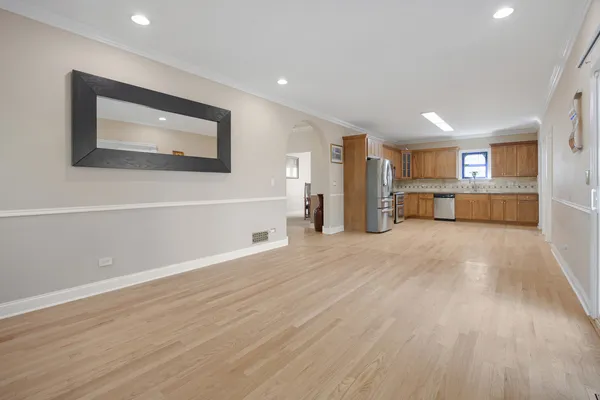 a view of a room with wooden floor and a window
