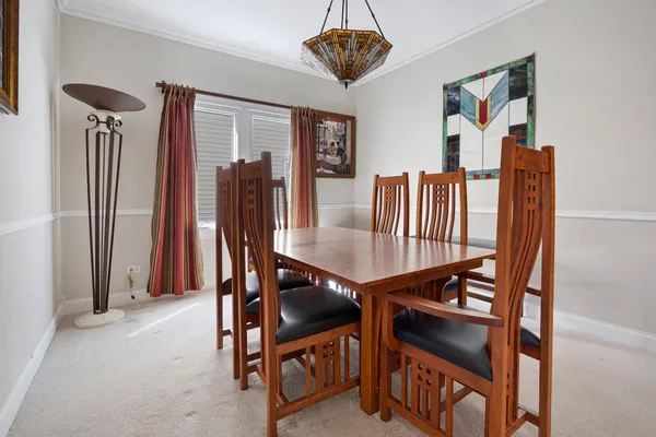 a view of a dining room with furniture and a chandelier