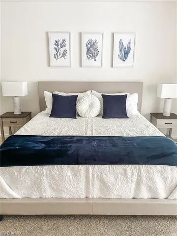 a bedroom with a large bed and a lamp