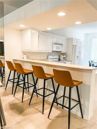 a kitchen with a table chairs sink and cabinets
