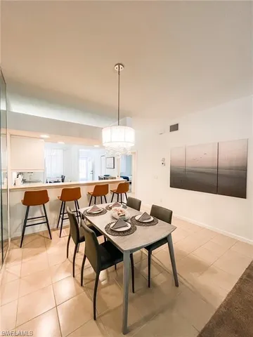 a dinning table and chairs in a kitchen