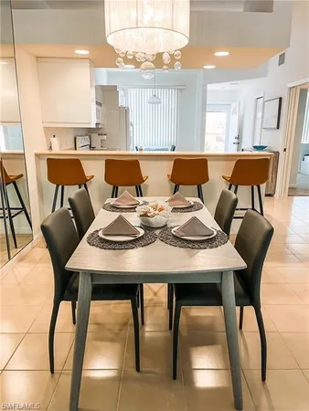 a view of a dining room with furniture and a chandelier