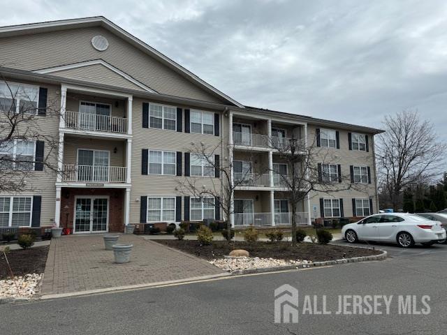 71 Liddle Avenue Edison, NJ 08837 - Photo 2 of 12 a front view of a building with lot of cars and trees