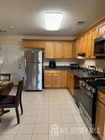 a kitchen with a sink a stove and a refrigerator