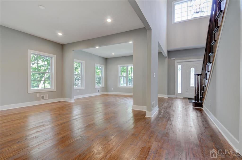 127 North Hill Road Colonia, NJ 07067 - Photo 13 of 40 an empty room with wooden floor and windows
