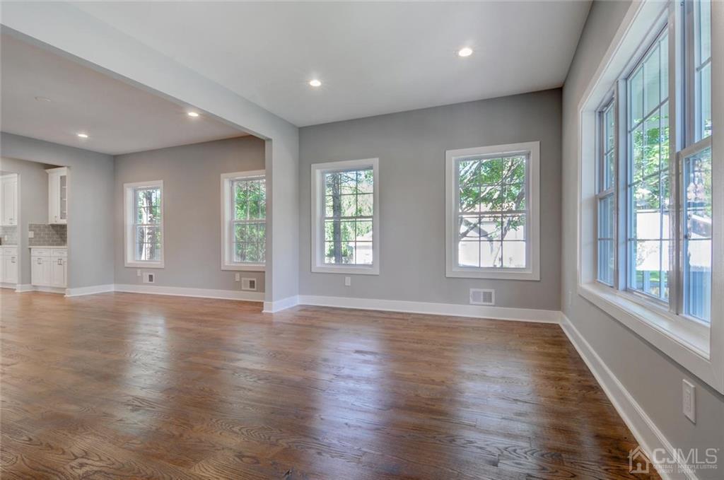 127 North Hill Road Colonia, NJ 07067 - Photo 14 of 40 an empty room with wooden floor and windows