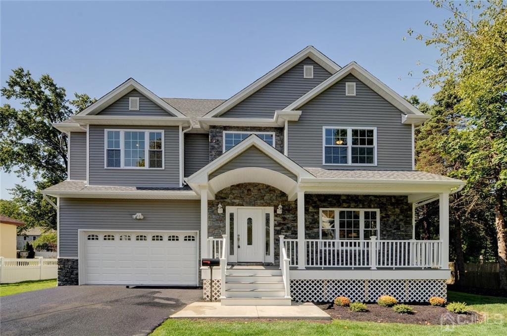 127 North Hill Road Colonia, NJ 07067 - Photo 2 of 40 a front view of a house with a yard and garage