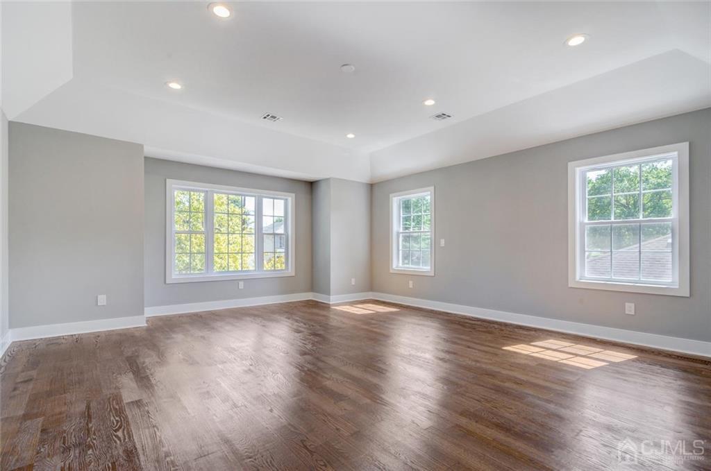 127 North Hill Road Colonia, NJ 07067 - Photo 24 of 40 a view of an empty room with wooden floor and a window