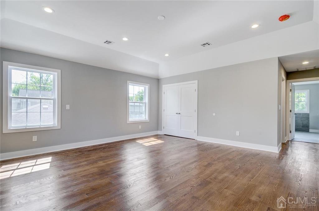 127 North Hill Road Colonia, NJ 07067 - Photo 25 of 40 a view of an empty room with wooden floor and a window