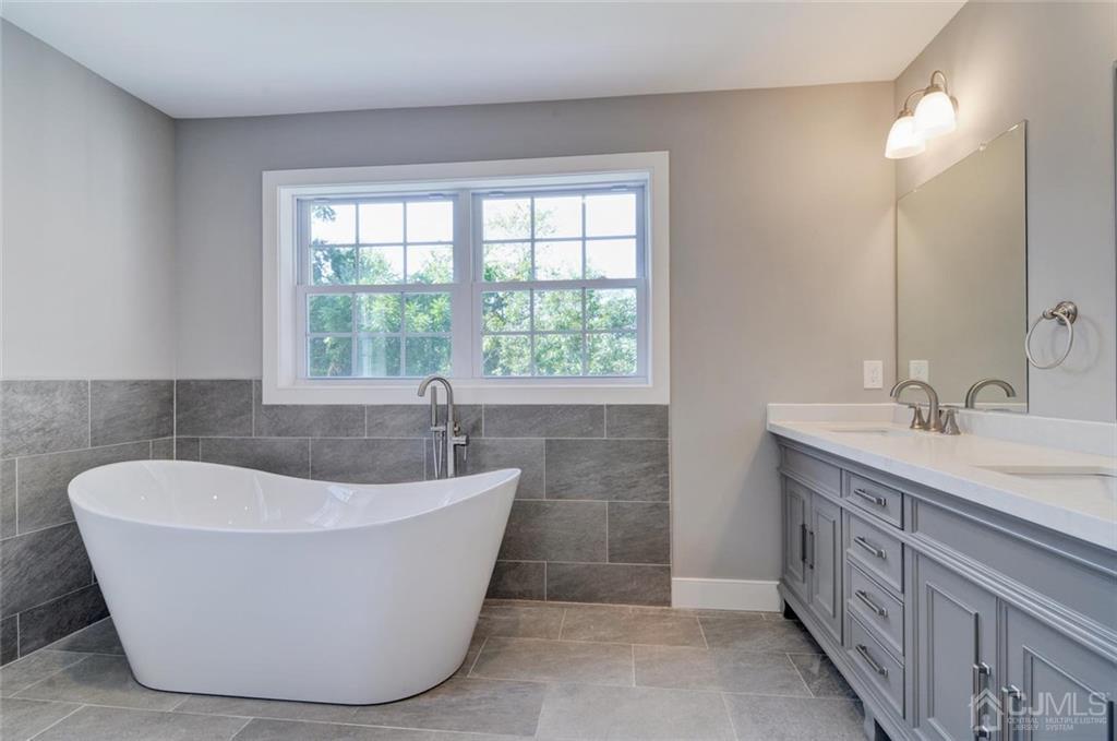 127 North Hill Road Colonia, NJ 07067 - Photo 33 of 40 a bath tub sitting in a bathroom next to a window