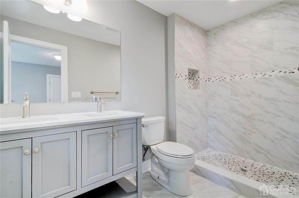 127 North Hill Road Colonia, NJ 07067 - Photo 36 of 40 a bathroom with a sink a toilet and shower